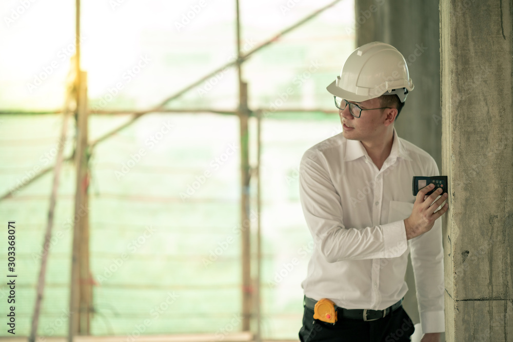 Engineer checking defect in construction site measure dimention of window on wall panel Engineer checking defect in construction site measure dimention of window on wall panel