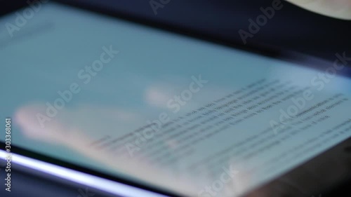 Macro close up of female hand swiping text on an ipad tablet device 4
