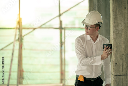 Engineer checking defect in construction site measure dimention of window on wall panel