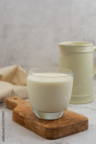 Jug and glass with milk on bright background isolated. Breakfast drink. Dairy.