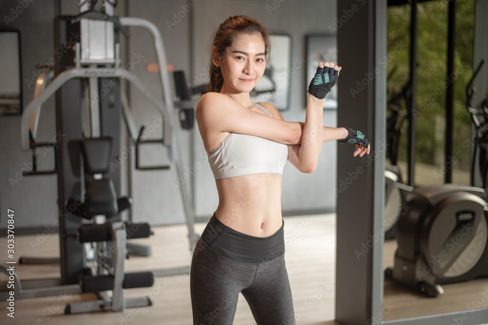 Beautiful asian woman is doing exercise in the gym Beautiful asian woman is doing exercise in the gym