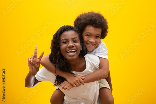 African brother and sister. Siblings bonding. Smiling black children hugging. photo