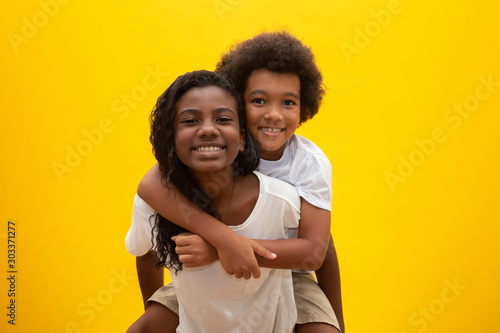 African brother and sister. Siblings bonding. Smiling black children hugging. photo