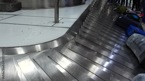 Receiving baggage at the airport. Passengers are waiting for their luggage after arrival.