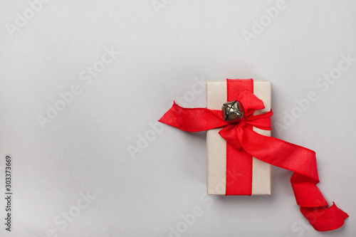 elongated gift box with a red ribbon on a gray background. blank for postcard, poster, banner, place for your text