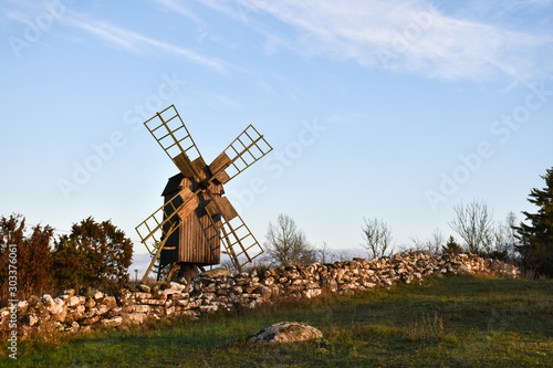 Old dry stone wall and a traditional windmill