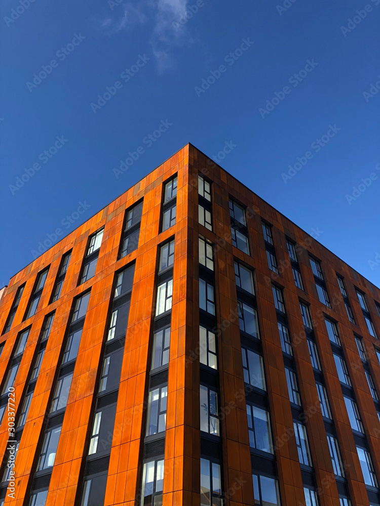 Low angle view of new rust coloured building in Sheffield