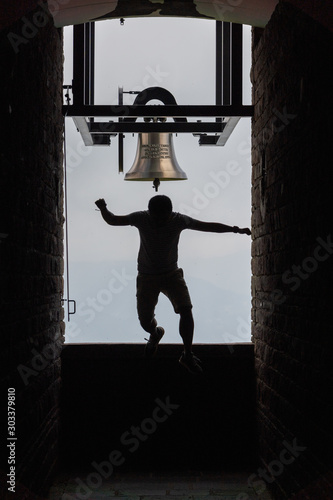 Man jumping off bell in Chapel Santa Maria degli Angeli on top of Monte Tamaro