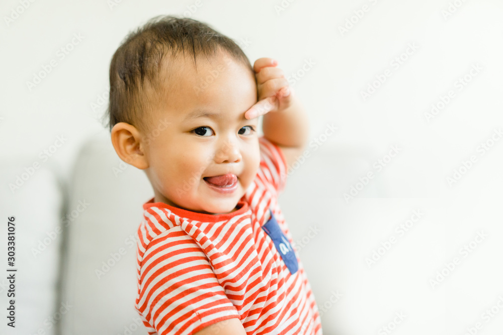2 year old toddler asian boy uncontrollable and bad behavior and show funny face at home.Attention deficit hyperactivity disorder (ADHD) Concept. 2 year old toddler asian boy uncontrollable and bad behavior and show funny face at home.Attention deficit hyperactivity disorder (ADHD) Concept.