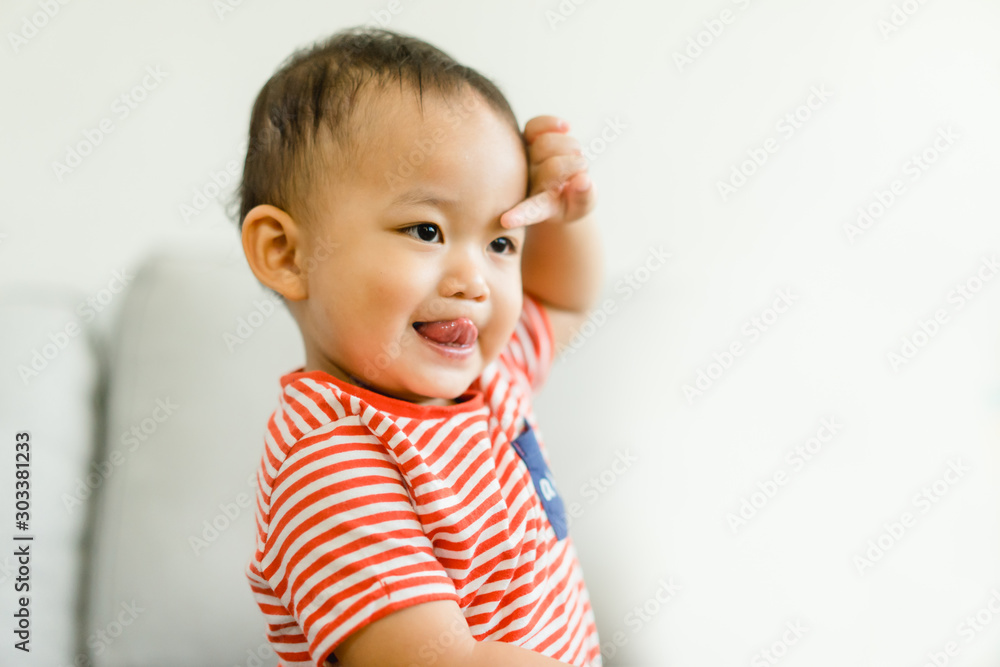 2 year old toddler asian boy uncontrollable and bad behavior and show funny face at home.Attention deficit hyperactivity disorder (ADHD) Concept. 2 year old toddler asian boy uncontrollable and bad behavior and show funny face at home.Attention deficit hyperactivity disorder (ADHD) Concept.