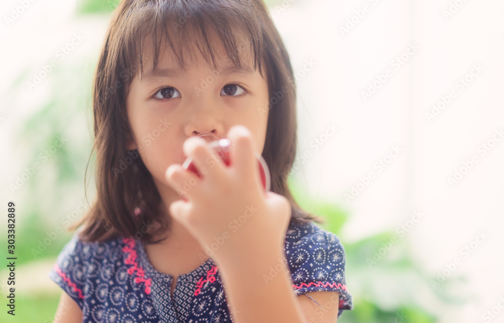Happy Little scientist asian girl with red liquid into flask and shaking on white background.Home school girl learning about science and pouring reagent into flask.Chemistry class at home. Happy Little scientist asian girl with red liquid into flask and shaking on white background.Home school girl learning about science and pouring reagent into flask.Chemistry class at home.