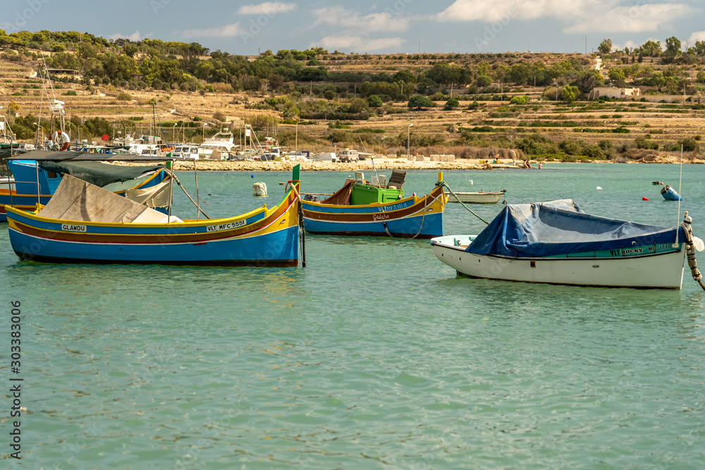 view of the harbor with boats, of marsaxlokk on malta view of the harbor with boats, of marsaxlokk on malta