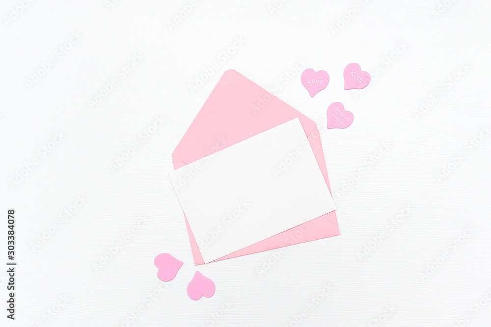 Love Letter. Pink envelope with white blank card and hearts on white background. Top view Flat lay Mockup for your text. Valentines day, Mothers day, Womens day greeting card Love Letter. Pink envelope with white blank card and hearts on white background. Top view Flat lay Mockup for your text. Valentines day, Mothers day, Womens day greeting card