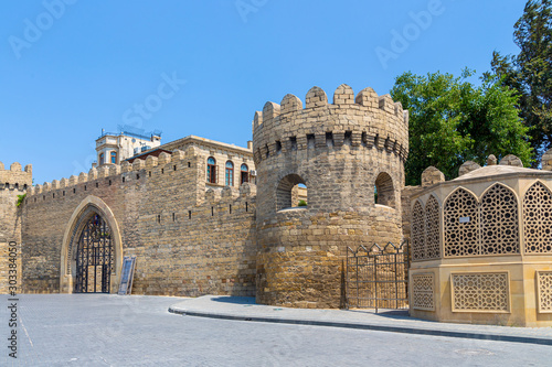 Central entrance and the fortress wall with the tower of the old city of Icheri Sheher photo