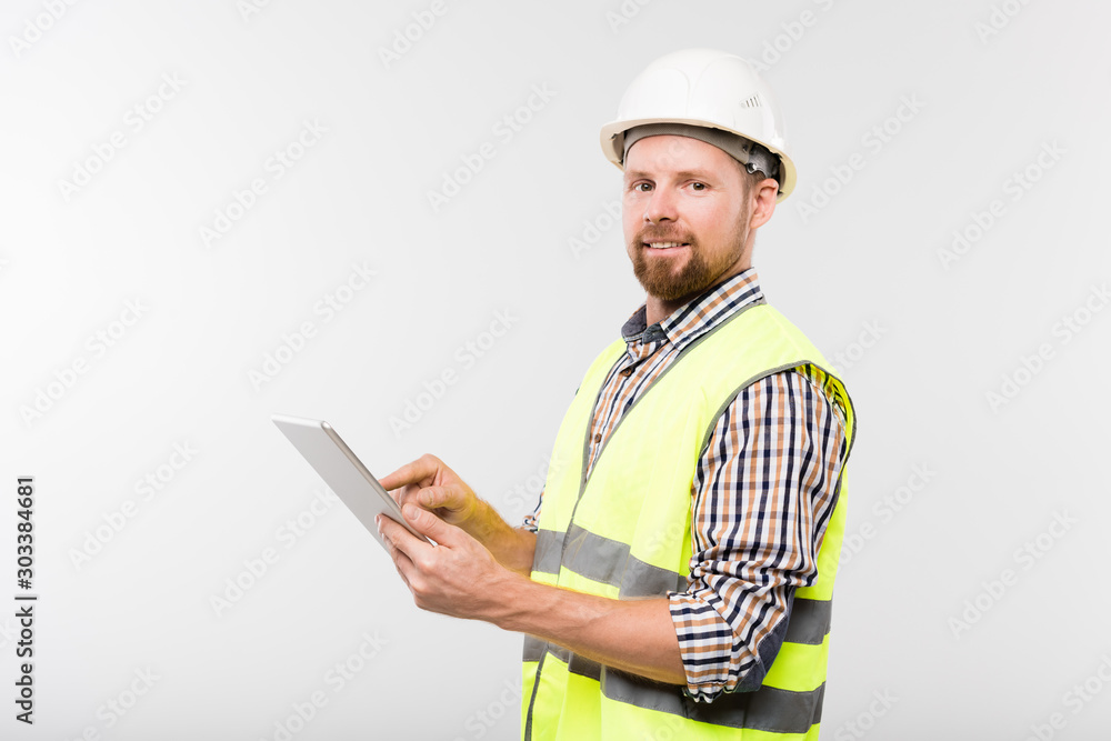 Young successful builder in white hardhat Young successful builder in white hardhat