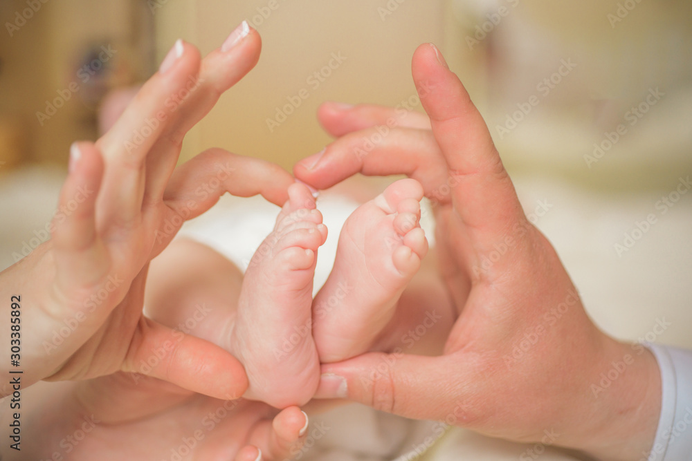 Baby feet in mother hands. Mom and her Child. Happy Family concept. Beautiful conceptual image of Maternity. Life.