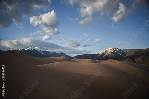dune with mountains in the background