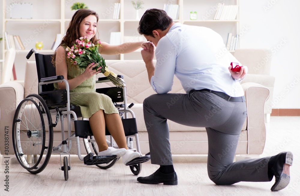 The man making marriage proposal to disabled woman on wheelchair The man making marriage proposal to disabled woman on wheelchair
