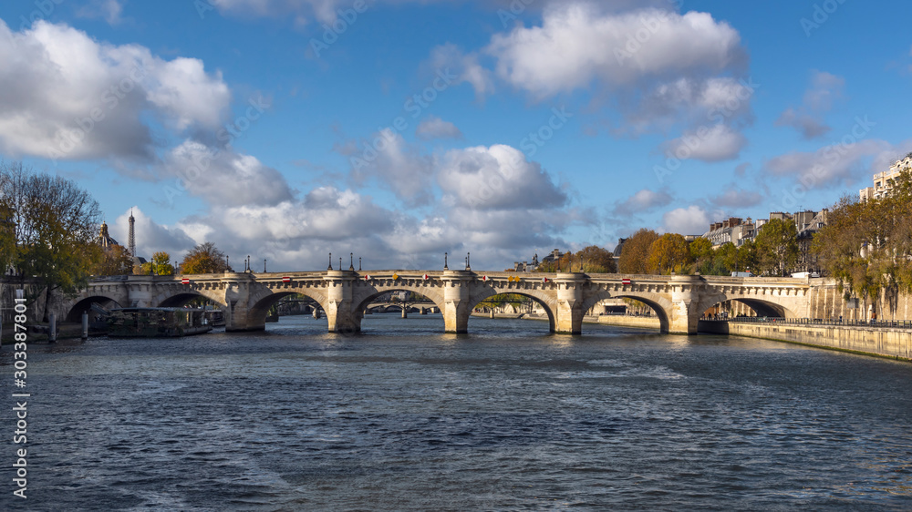 Famous stone bridge, Pont Neuf in Paris on sunny autumn day. Picture taken from the boat on the Seine River