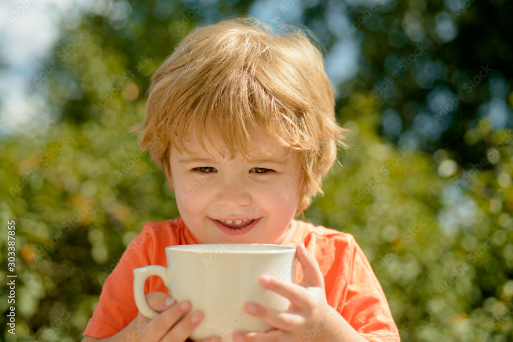 Food and drink. Cheerful boy with a cup of milk. Cocoa for breakfast at the cottage for child. Healthy drink. Happy child. Tasty food. Food and drink. Cheerful boy with a cup of milk. Cocoa for breakfast at the cottage for child. Healthy drink. Happy child. Tasty food.