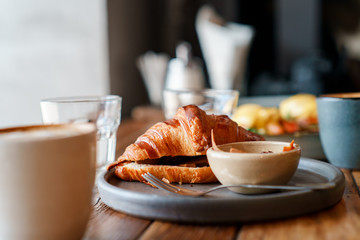 breakfast with eggs and coffee and croissant