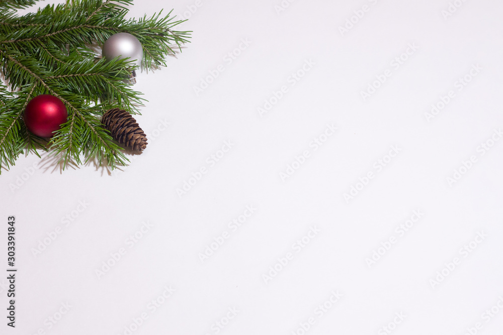 Christmas composition of fir branches, cones and balls on a white background