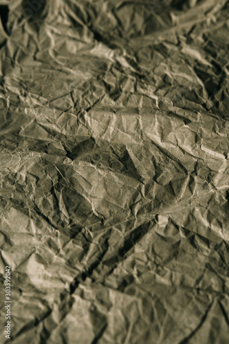 Texture of crumpled brown paper. Rough paper background for design. Abstract texture and background made with wrinkled paper.