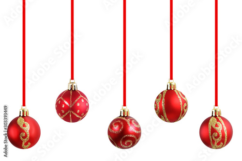 Christmas red balls with golden sparkles hanging on a ribbon for a Christmas tree close-up. White isolate.