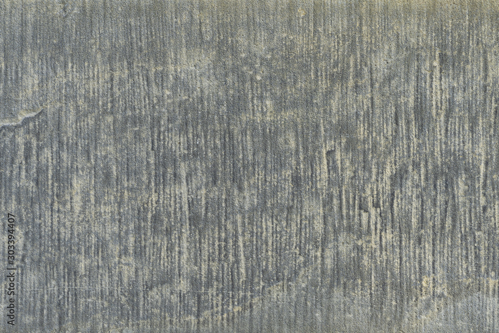 Old gray concrete slab wall close-up. Gray striped grungy surface texture, background for interior design. Weathered natural. Old gray concrete slab wall close-up. Gray striped grungy surface texture, background for interior design. Weathered natural.