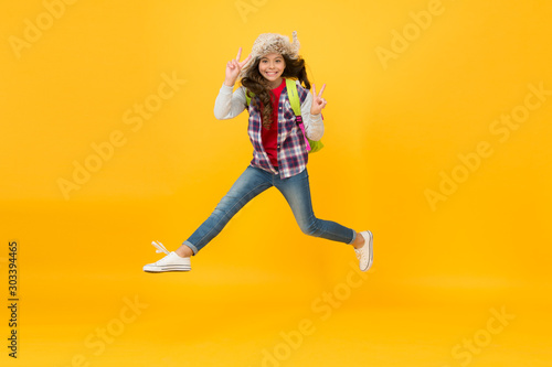 Keep moving. Winter season concept. Kid girl wear hat with ear flaps. Winter events at school. Winter entertainment and activities. Child active schoolgirl soft hat enjoy season. Winter vacations © be free
