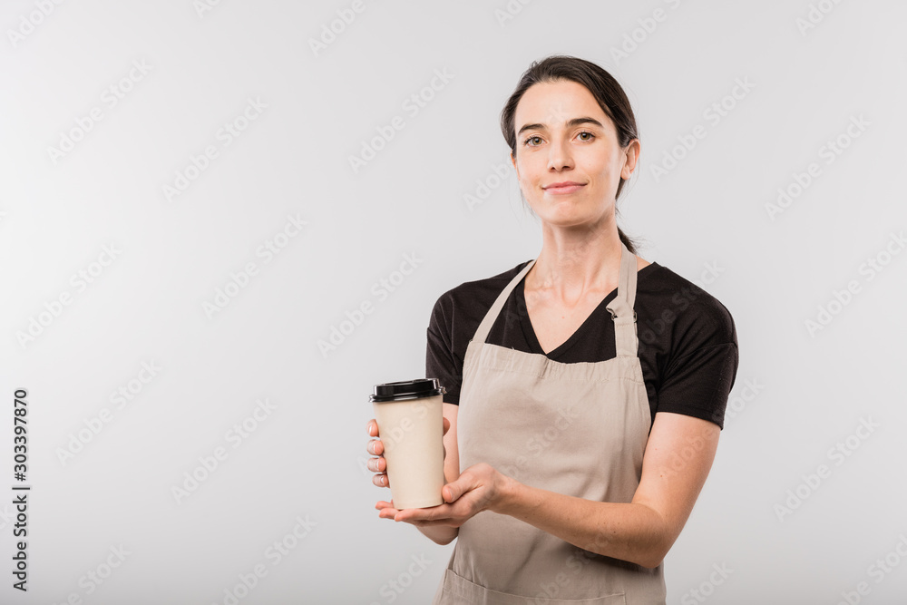 Pretty young waitress of cafe passing you disposable glass with hot coffee Pretty young waitress of cafe passing you disposable glass with hot coffee