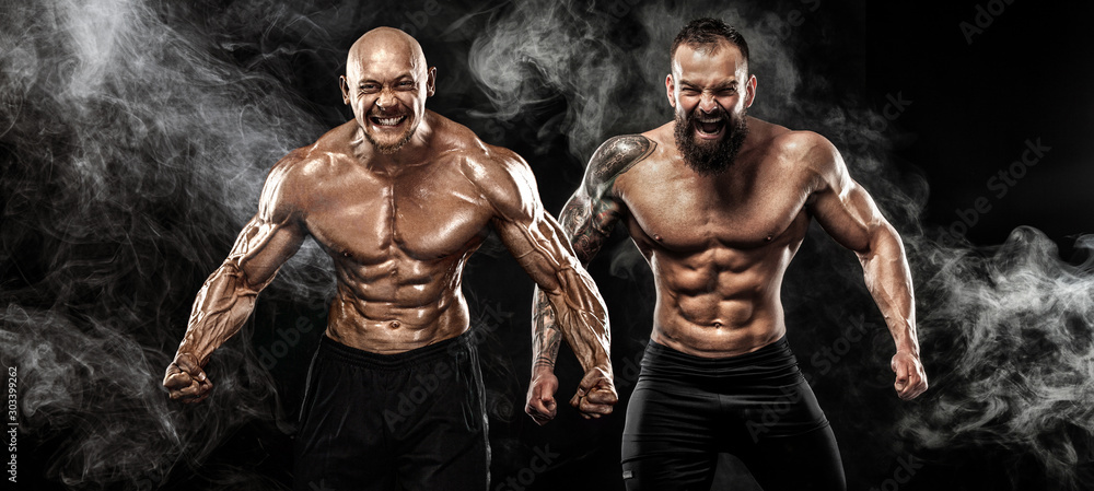 Sport and fitness concept. Two wild sportsmen boxers and bodybuilders posing on black background with smoke before competition or fight. Copy Space. - obrazy, fototapety, plakaty 