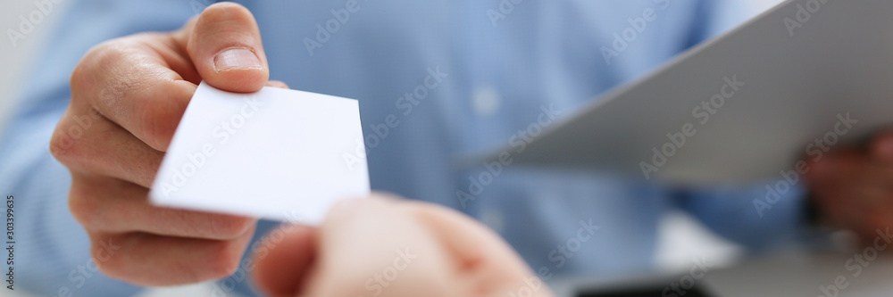 Male hand in suit give blank calling card Male hand in suit give blank calling card