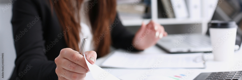 Female hand holding silver pen ready to make Female hand holding silver pen ready to make
