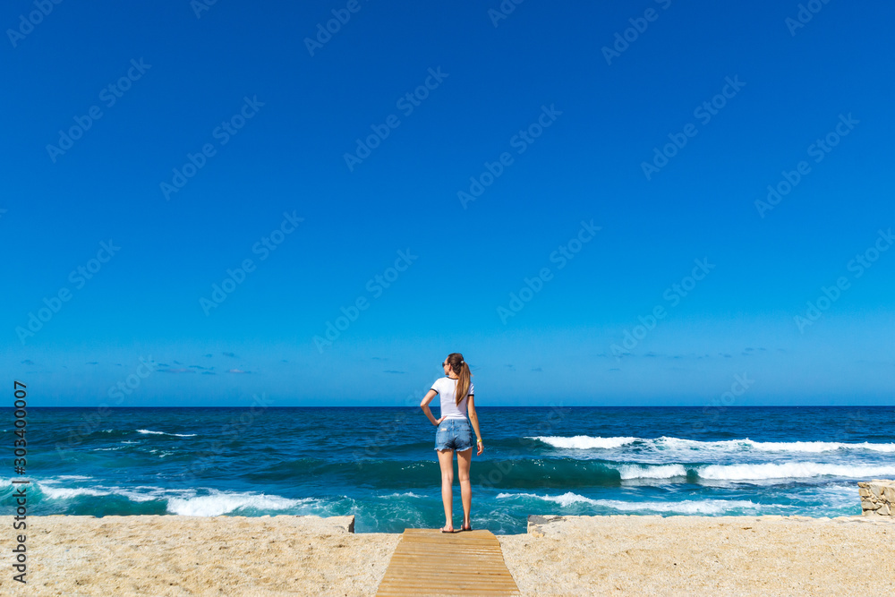 Young girl in sea coastline on Crete, Greece. Young girl in sea coastline on Crete, Greece.