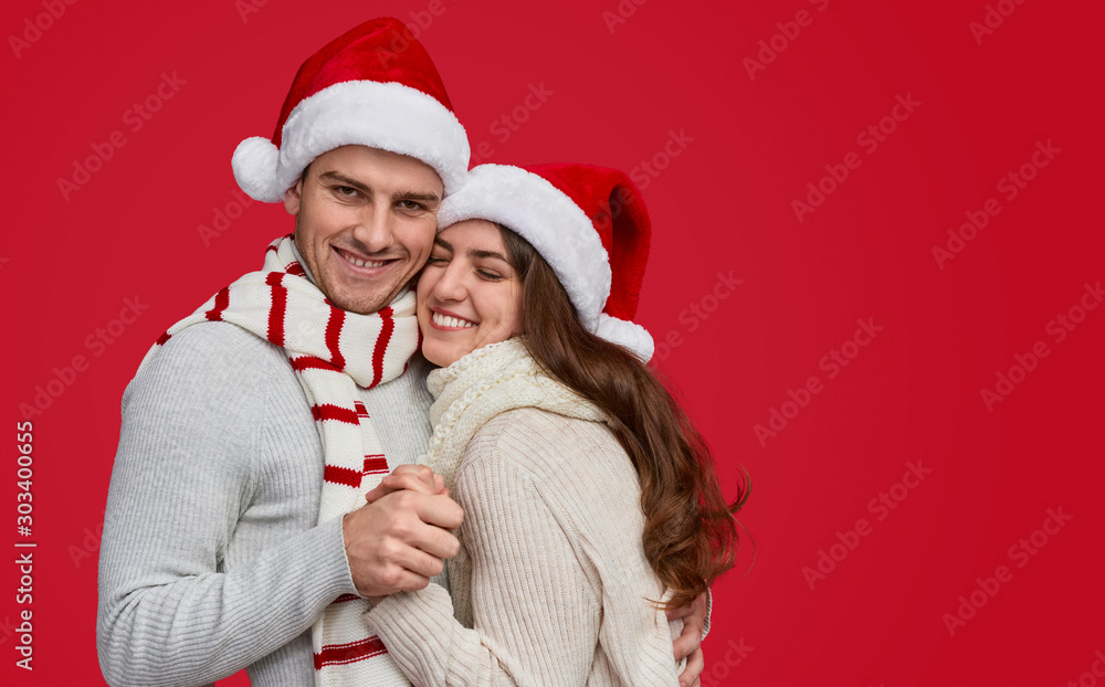 Happy couple embracing during Christmas party Happy couple embracing during Christmas party