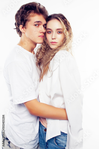 young pretty couple together posing cheerful isolated on white background, lifestyle people concept, happy boy and girl