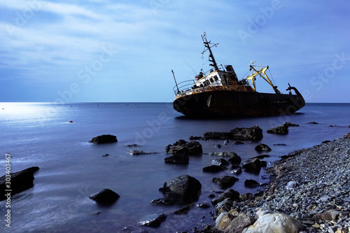 Ship on stones in the sea