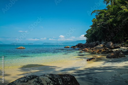 Ilha das Couves, Ubatuba, Sao Paulo, Brazil - Paradise tropical beach with white sand, blue and calm waters, without people on a sunny day and blue sky of the Brazilian coast in high resolution © GAMAPictures