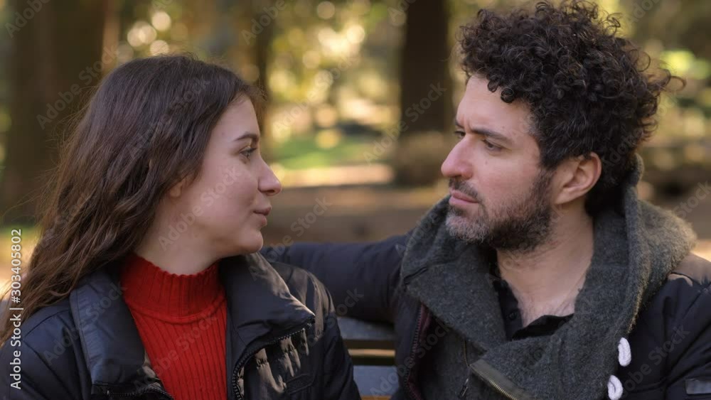 unrequited love.Man trying to kiss young woman in the park,she refusing kiss him unrequited love.Man trying to kiss young woman in the park,she refusing kiss him