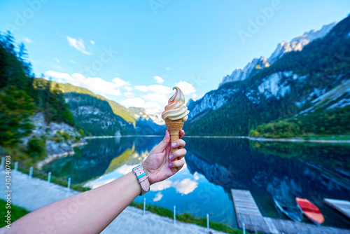 Konstfotografi Beautiful Gosausee lake landscape with hand and ice cream, Dachstein mountains,