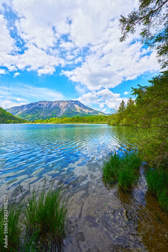 Beautiful Offensee lake landscape with mountains  forest  clouds and reflections in the water in Austrian Alps. Salzkammergut region.