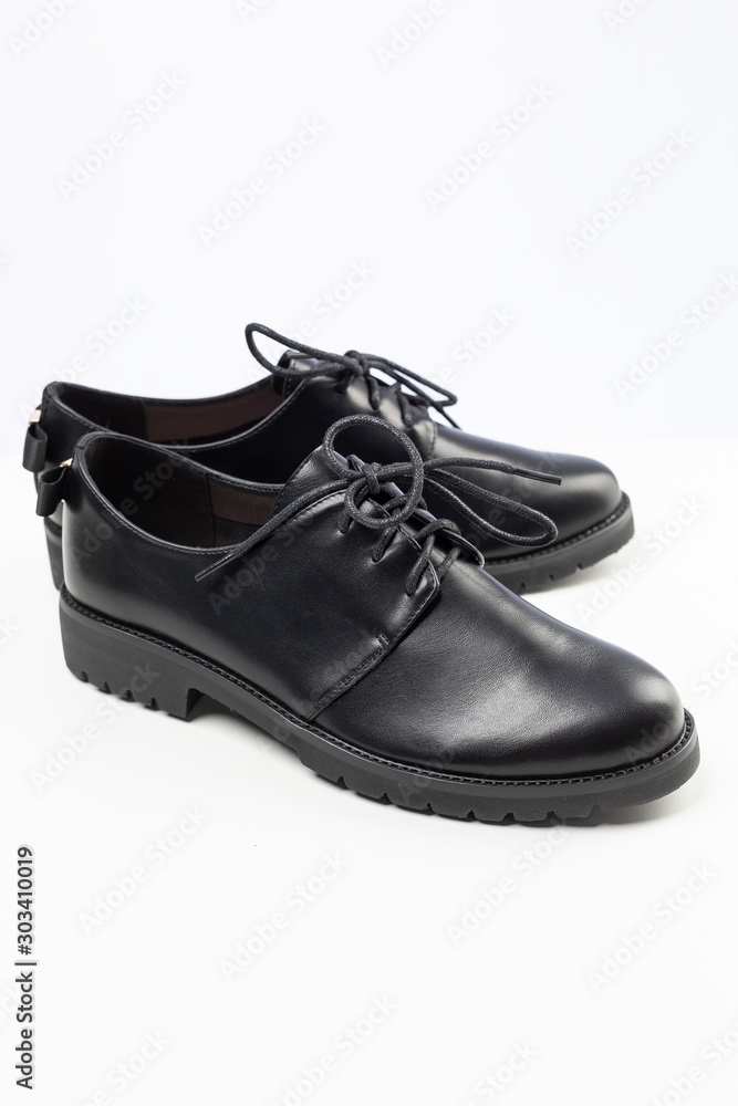 black new leather shoes on white background