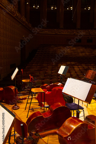 Music books and sheets with musical notation on the stands ready to the concert. Equipment of the Orchestra in philharmonia photo