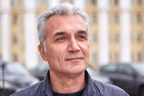 Successful middle-aged man in casual wear outdoors photo