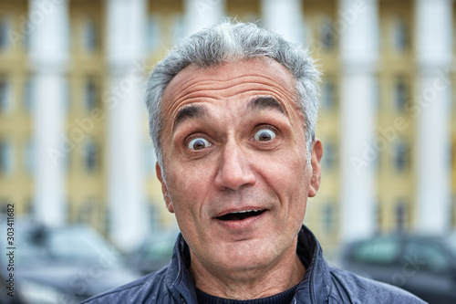Street portrait of a surprised middle-aged man.