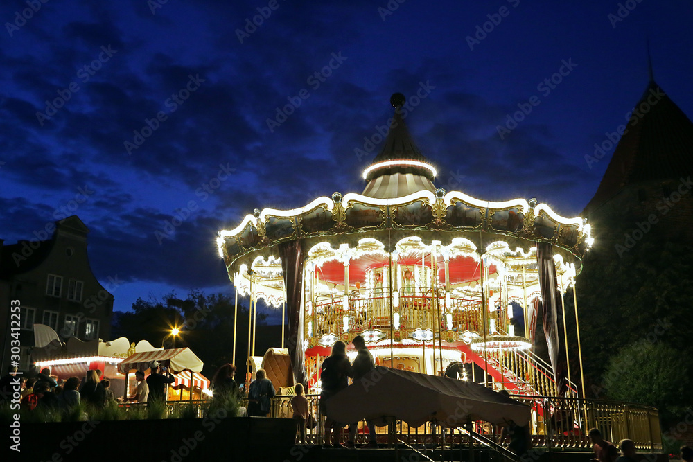 Fototapeta premium Poland, Gdansk 08.16.2019: Children's carousel in the waterfront area.