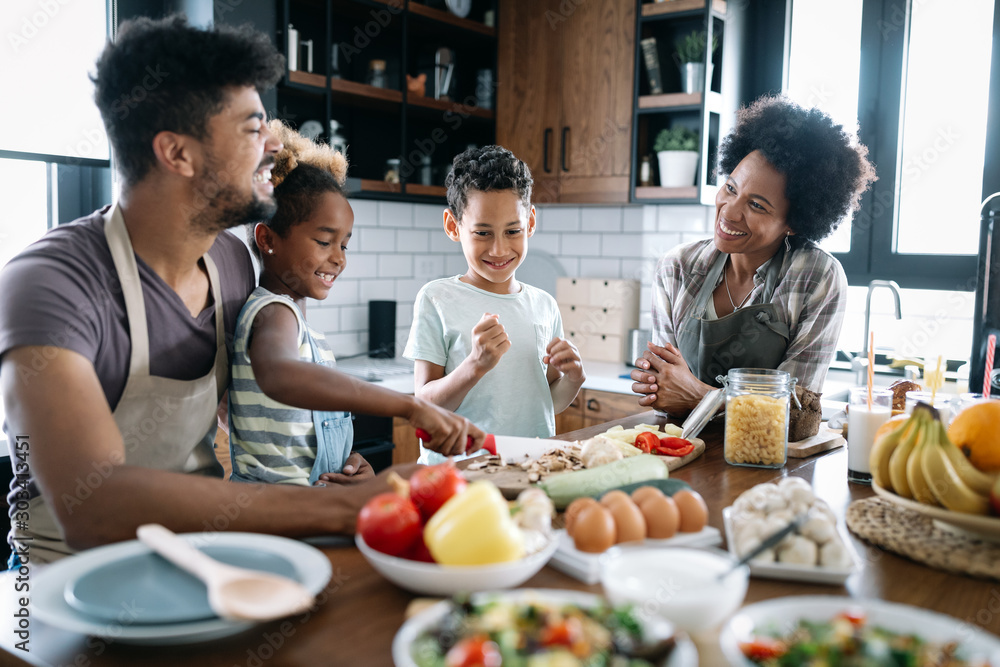 Happy family in the kitchen having fun and cooking together. Healthy food at home. Happy family in the kitchen having fun and cooking together. Healthy food at home.