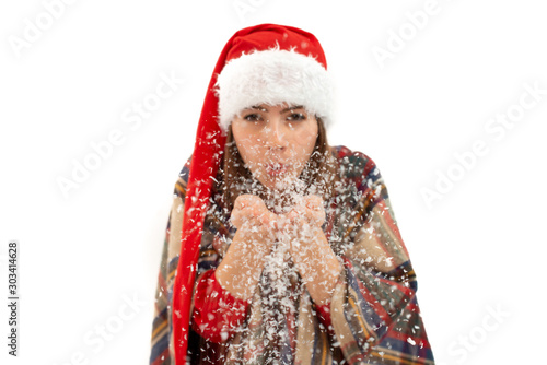 An isolated shot of a  woman celebrating christmas and blowing snow
