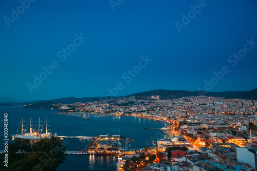 Kusadasi, Aydin Province, Turkey. Waterfront And Kusadasi Cityscape In Summer Evening. Night Scenic View Of Kusadasi Skyline At Aegean Coast, Turkey © Grigory Bruev